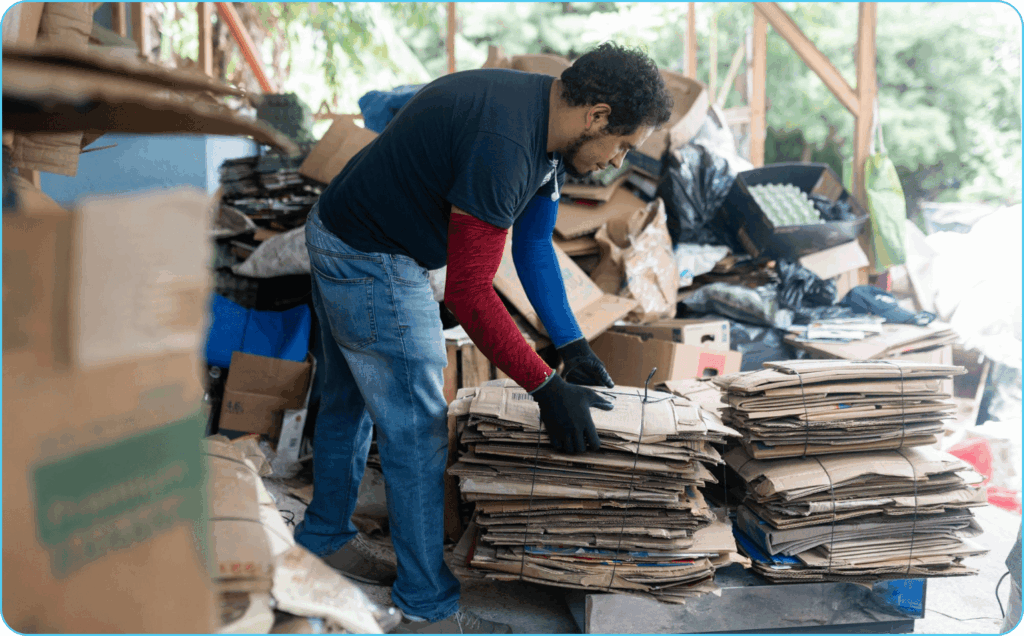 Man sorting and stacking cardboard for recycling