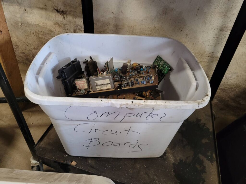 Plastic bin filled with old electronic circuit boards
